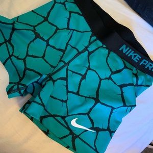 Women’s teal and black Nike pros